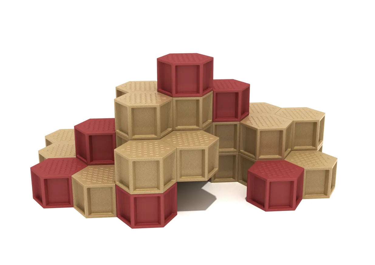 Tiered hexagonal climbing pods in warm red and tan with textured, grippy surfaces for secure footing and active play