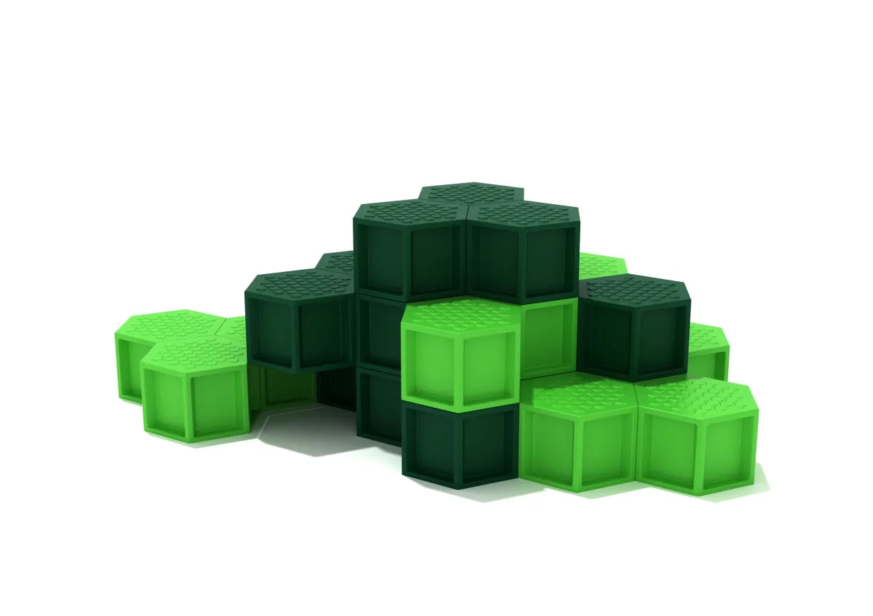 Stacked hexagonal playground platforms in dark and light green with textured surfaces for climbing and balancing.