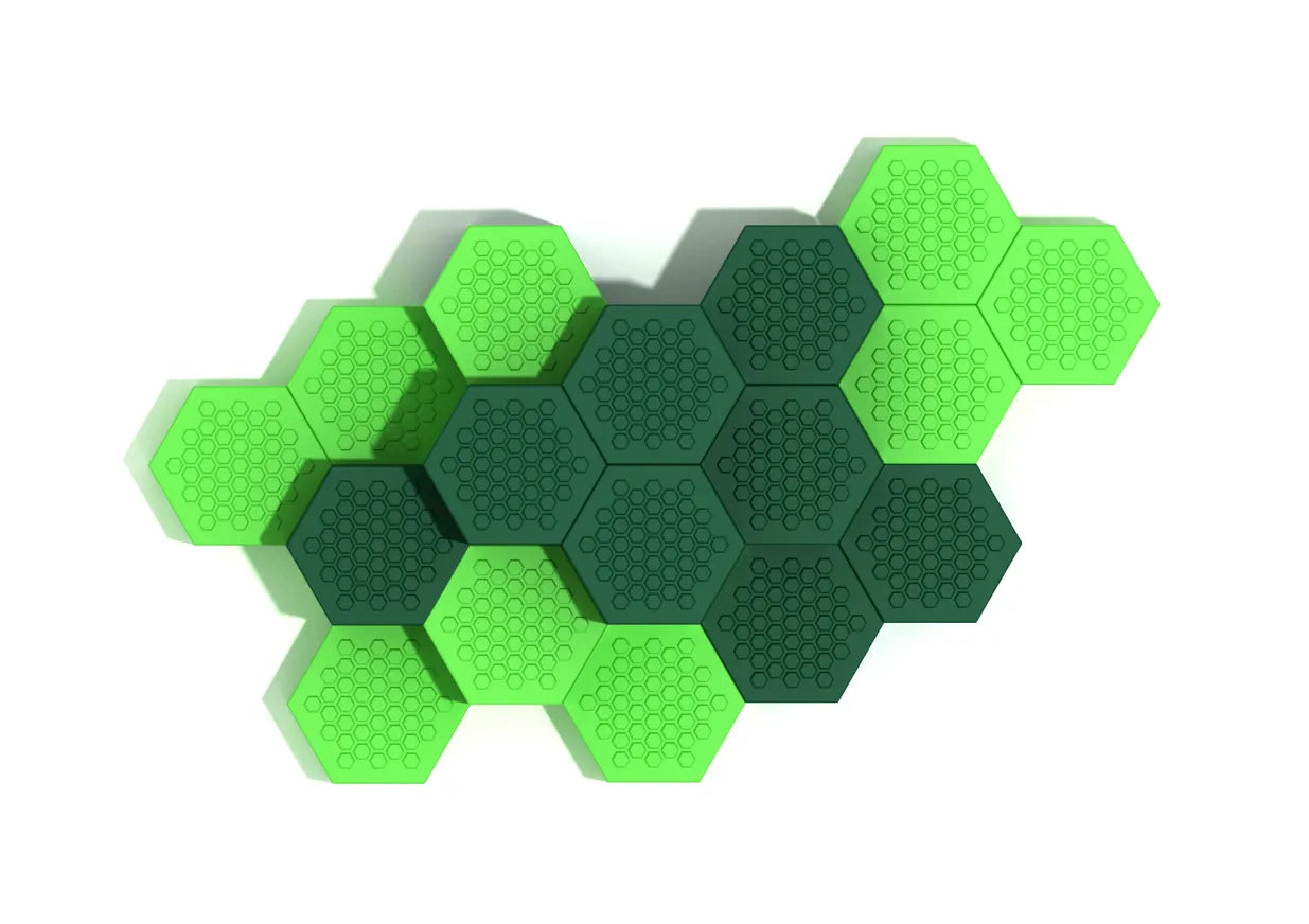 Overhead view of modular hexagonal climbing platforms in alternating green shades with textured surfaces for playground activity