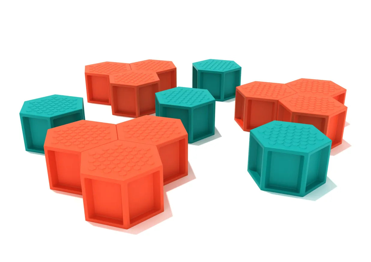 Colorful hexagonal climbing pods in orange and teal with textured tops arranged for active play and balance.