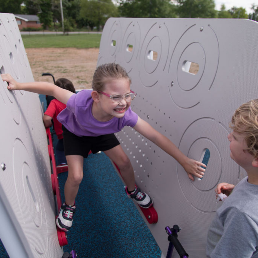 ActionFit Kids Hero Zone outdoor workout equipment with children climbing between two textured walls using hand holds and foot supports