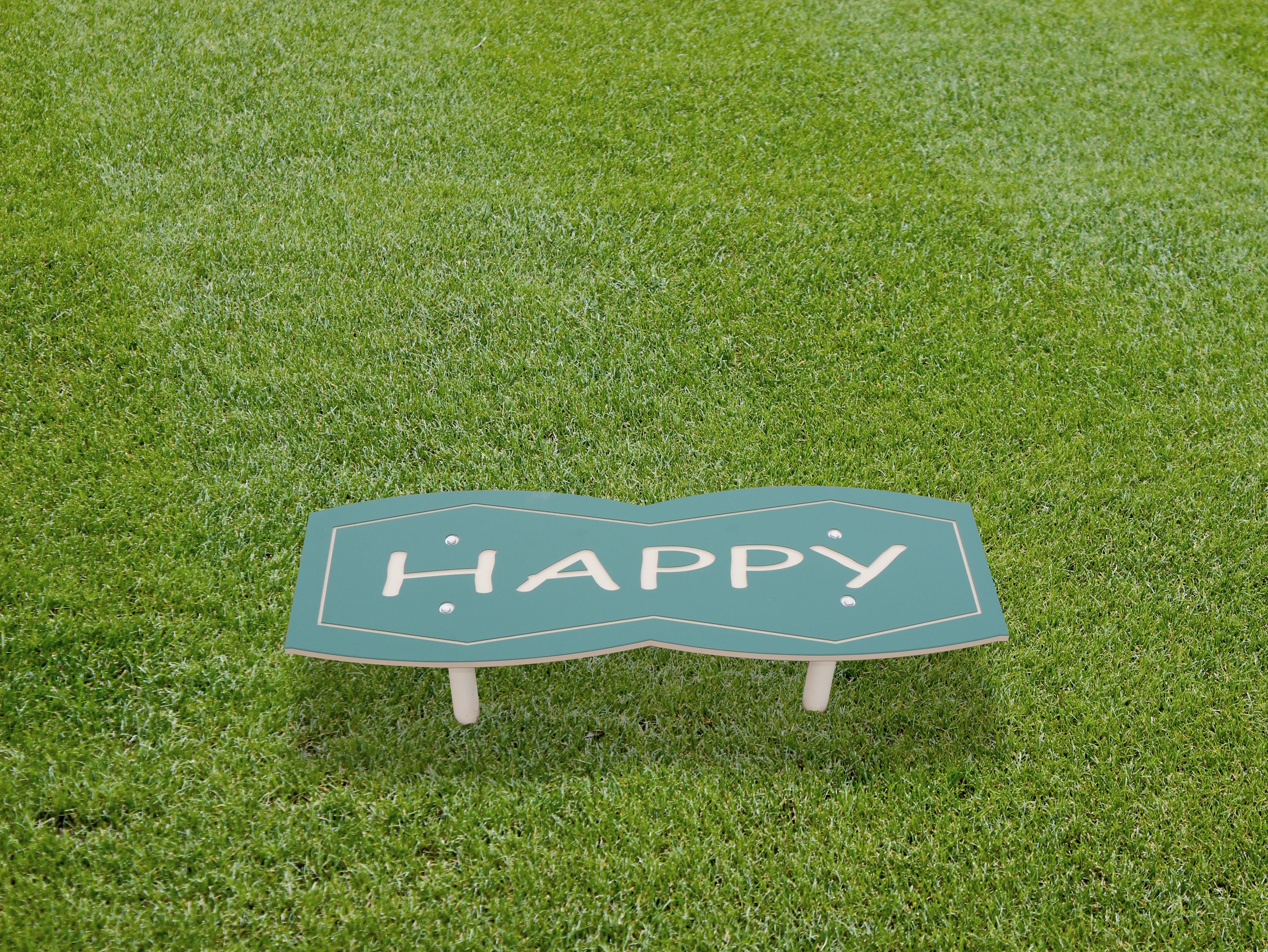 4-Foot Outdoor Character Bench Happy with green top, white legs, playful design, durable outdoor seating for parks and playgrounds
