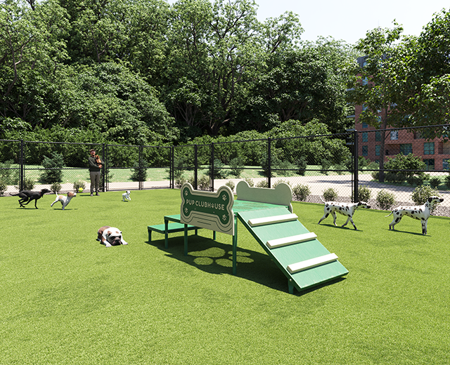 Green dog agility clubhouse with bone-shaped panels on artificial turf surrounded by playful dogs in a fenced park