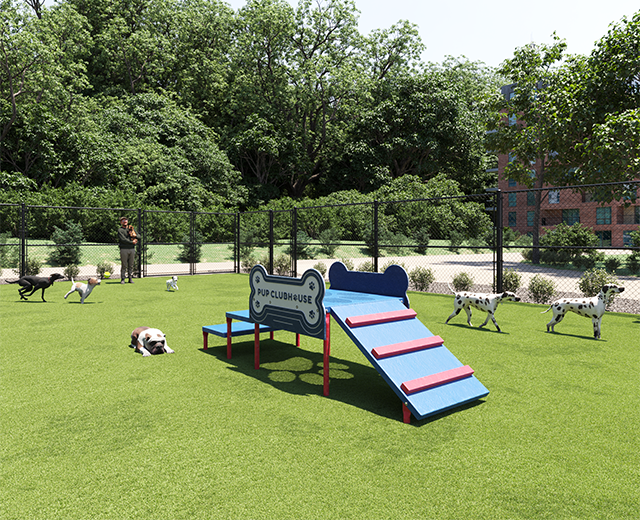 Dog agility clubhouse with bone-shaped panel and ramp on green turf, surrounded by small dog breeds.