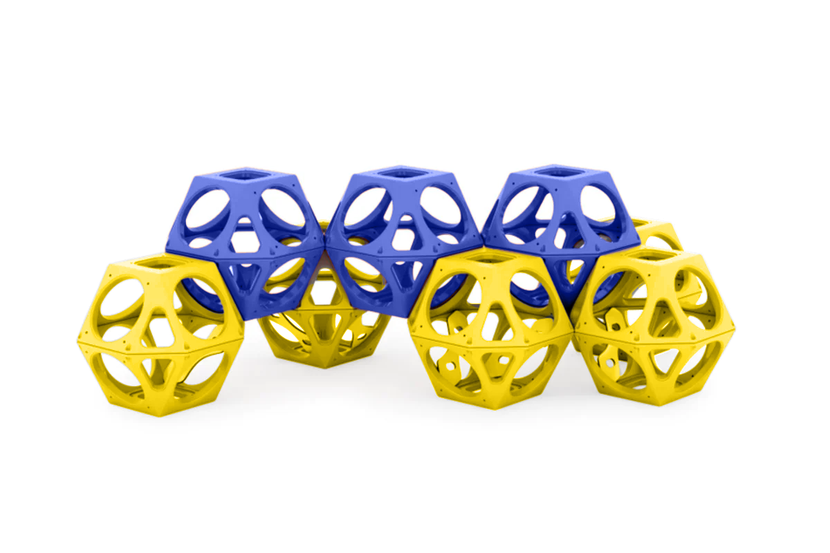 Interconnected blue and yellow climbing cubes with geometric cutouts forming a modular playground structure for active play and problem-solving.