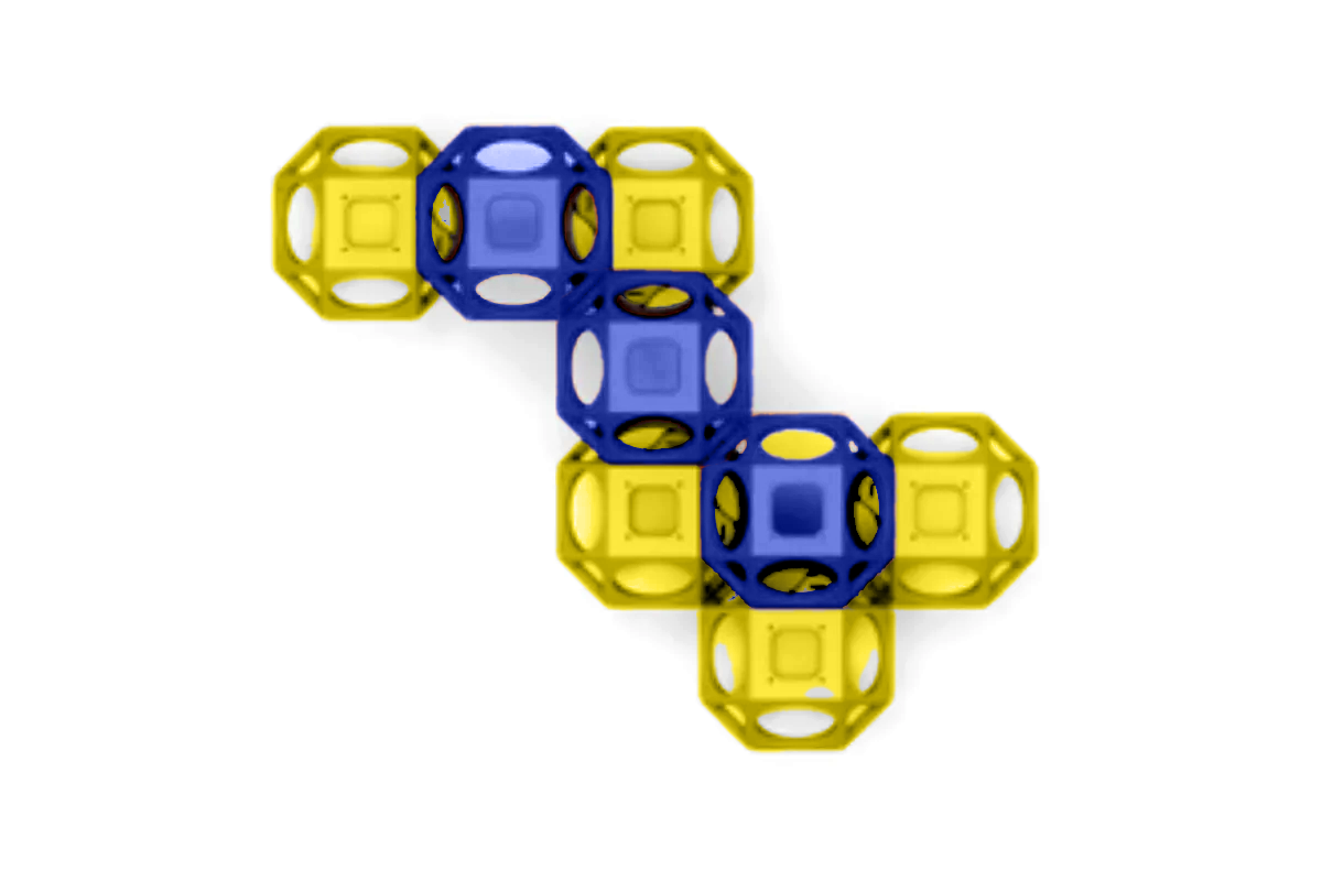Overhead view of interconnected blue and yellow climbing cubes with open circular sides for playground activity