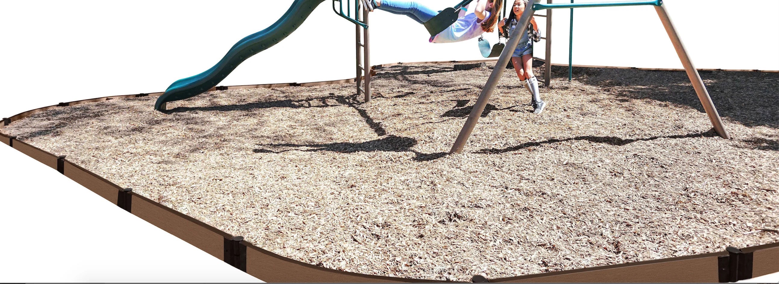 Curved playground border with wood chip safety surfacing around swing set and two children playing