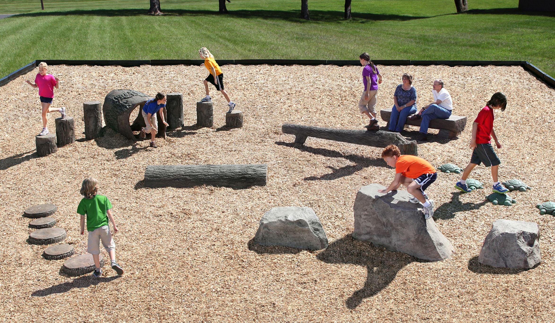 Children playing on a playground featuring nature-themed tree stump steppers and other natural play elements.
