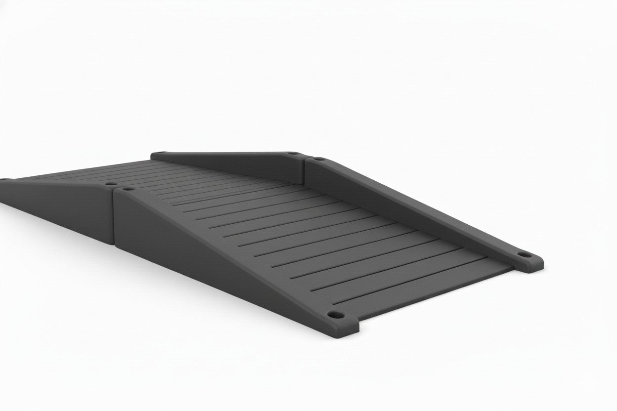 ADA Accessible Full Ramp playground ramp system with black textured surface, side rails, wheelchair accessible entry, surrounded by wood chips and grass