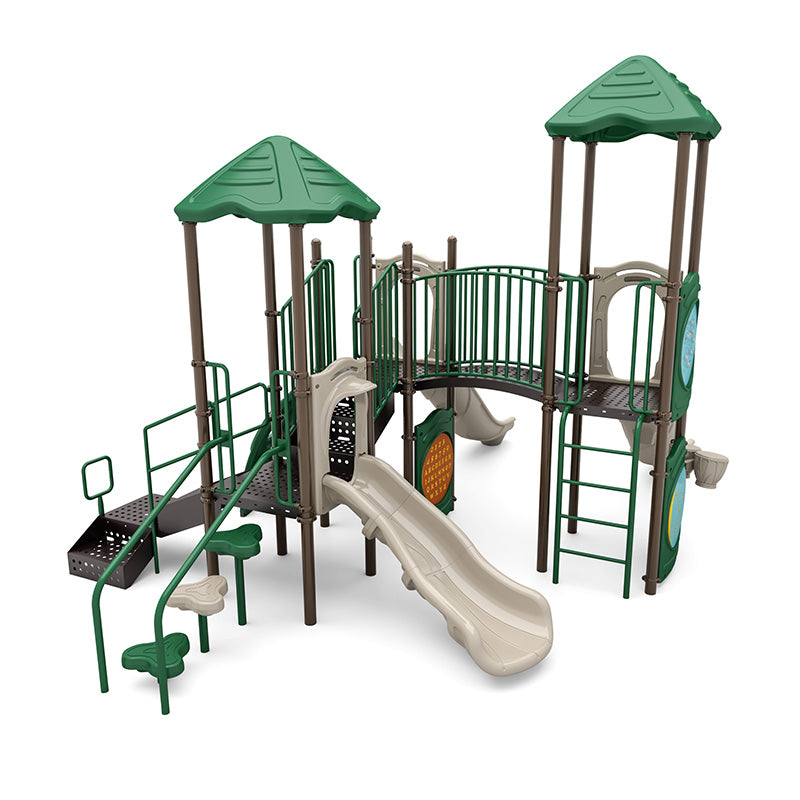 Playground structure with green roofs, beige slides, climbing elements, interactive panels, and a bridge connecting towers