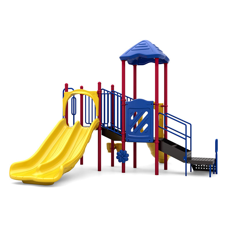 Colorful playground structure with double yellow slides, blue roof, red posts, climbing stairs, and interactive play panels