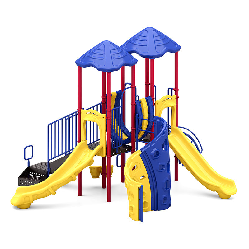 Colorful playground structure with two blue peaked roofs, yellow slides, climbing wall, and red support posts.