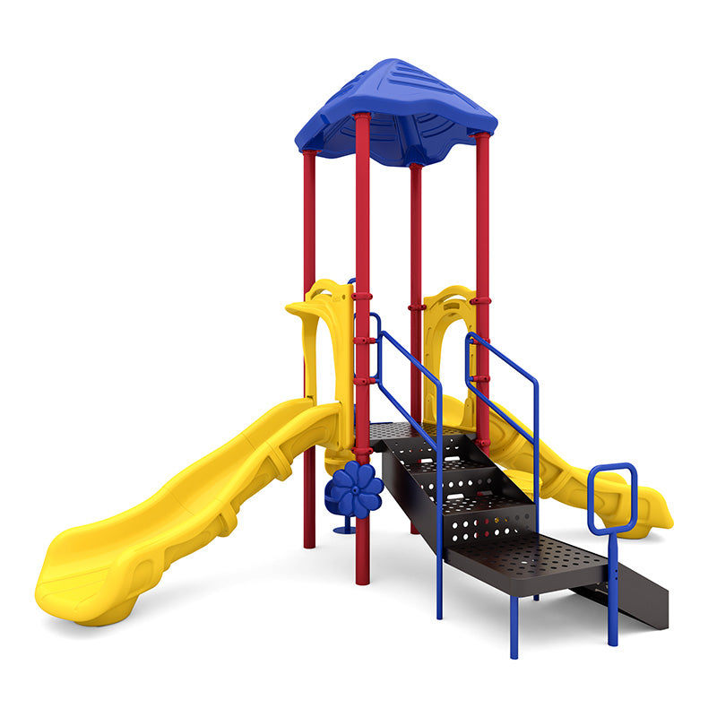 Colorful playground with dual yellow slides, blue roof, red posts, accessible ramp with handrails, and inclusive play features