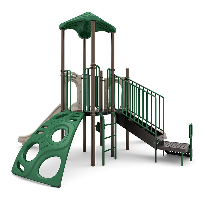 Compact playground structure with green climbing wall, right-turn slide, ladder, shaded platform with railings, and ADA transfer station.
