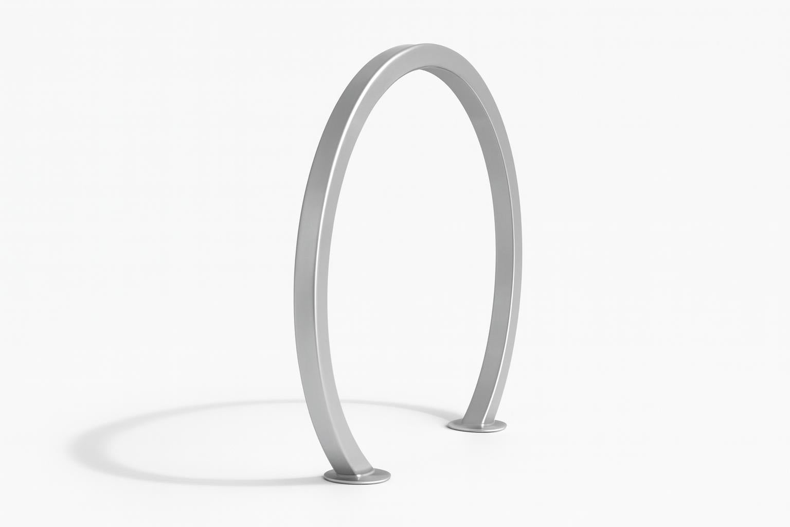 Horizons Bicycle Rack modern silver metal large hoop design surface mounted on concrete near grass and trees