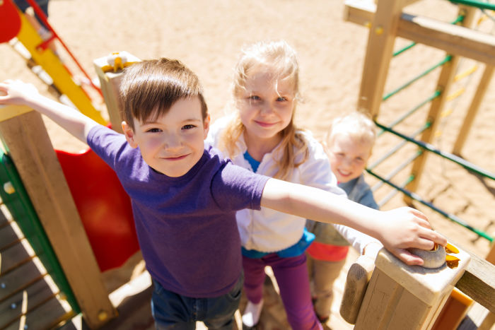 Kids Smiling and playing on Playground