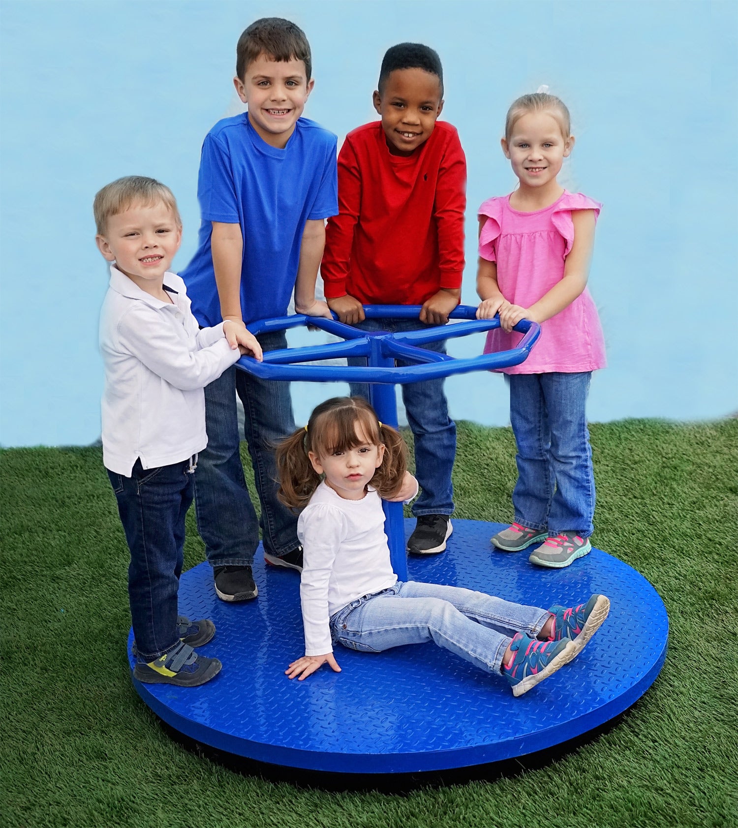 Blue steel merry-go-round with five children on artificial grass playground surface