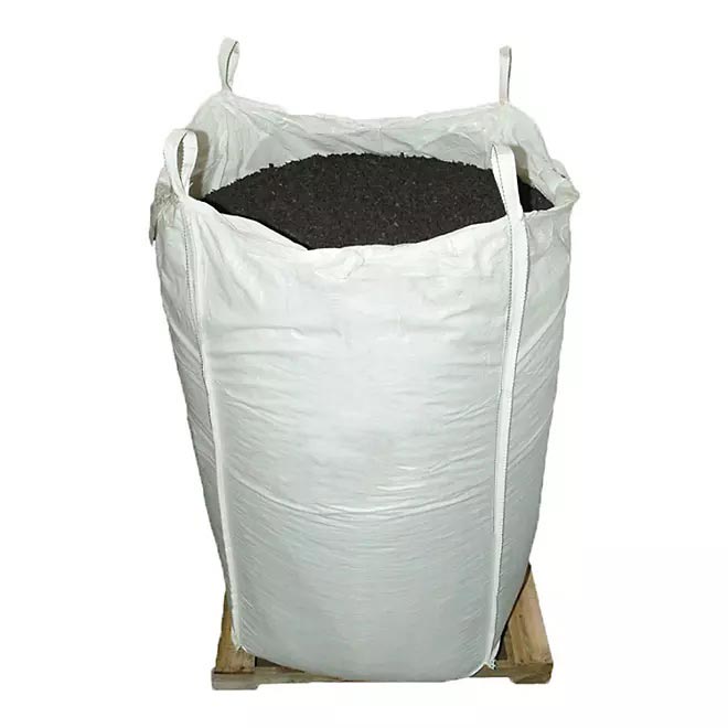 White bulk bag filled with black recycled rubber playground mulch on wooden pallet for safe, durable surfacing