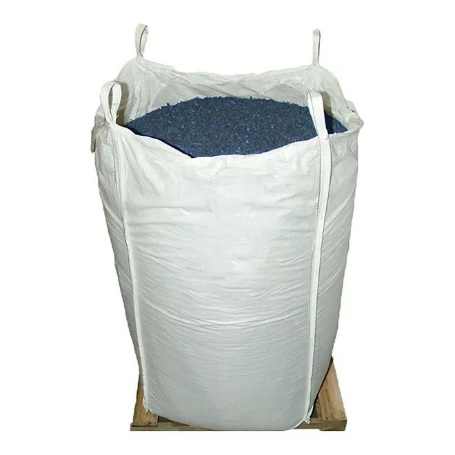 White bulk bag of vibrant blue recycled rubber playground mulch on wooden pallet for safe, durable surfacing