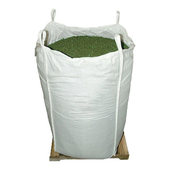 Large white bulk bag of green recycled rubber playground mulch on wooden pallet, durable and shock-absorbing surfacing material