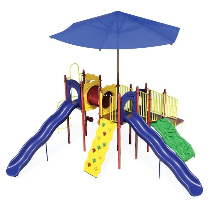 Colorful playground with two blue wave slides, climbing wall, tunnel, green ramp, and large blue shade canopy