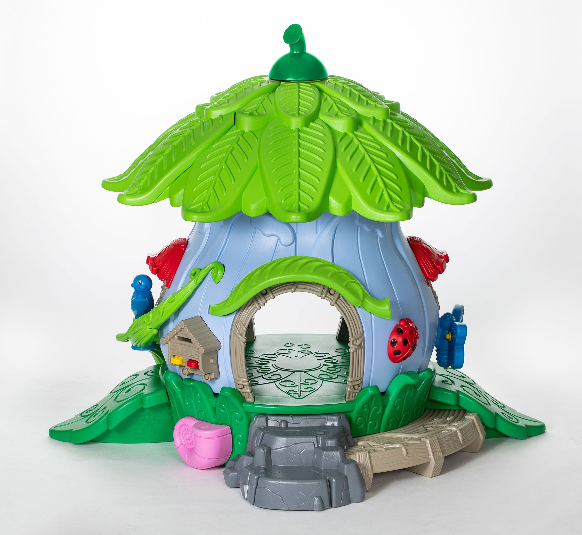 Nature-themed toddler playground playhouse with leaf roof, arched doorway, critter details, and steps for preschool play