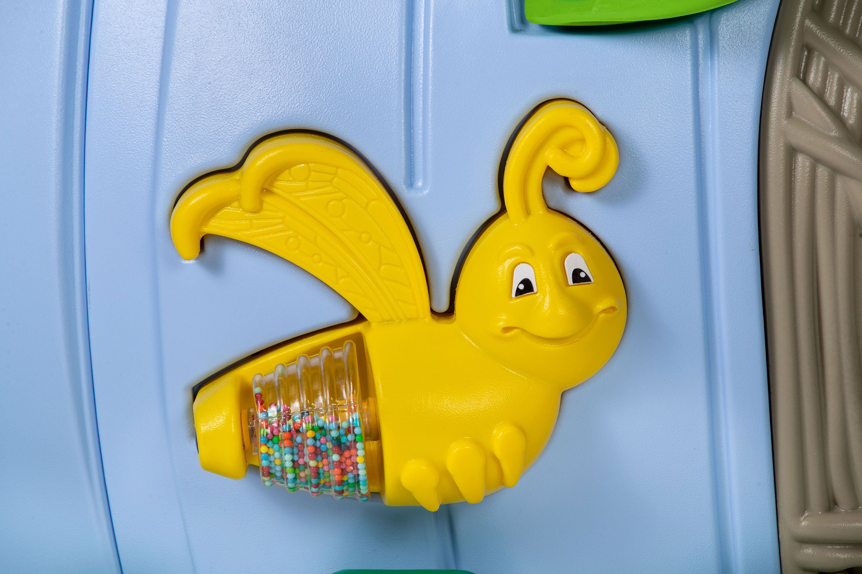 Interactive playground sensory panel with smiling yellow bee spinner and bead roller on blue backing for toddler play