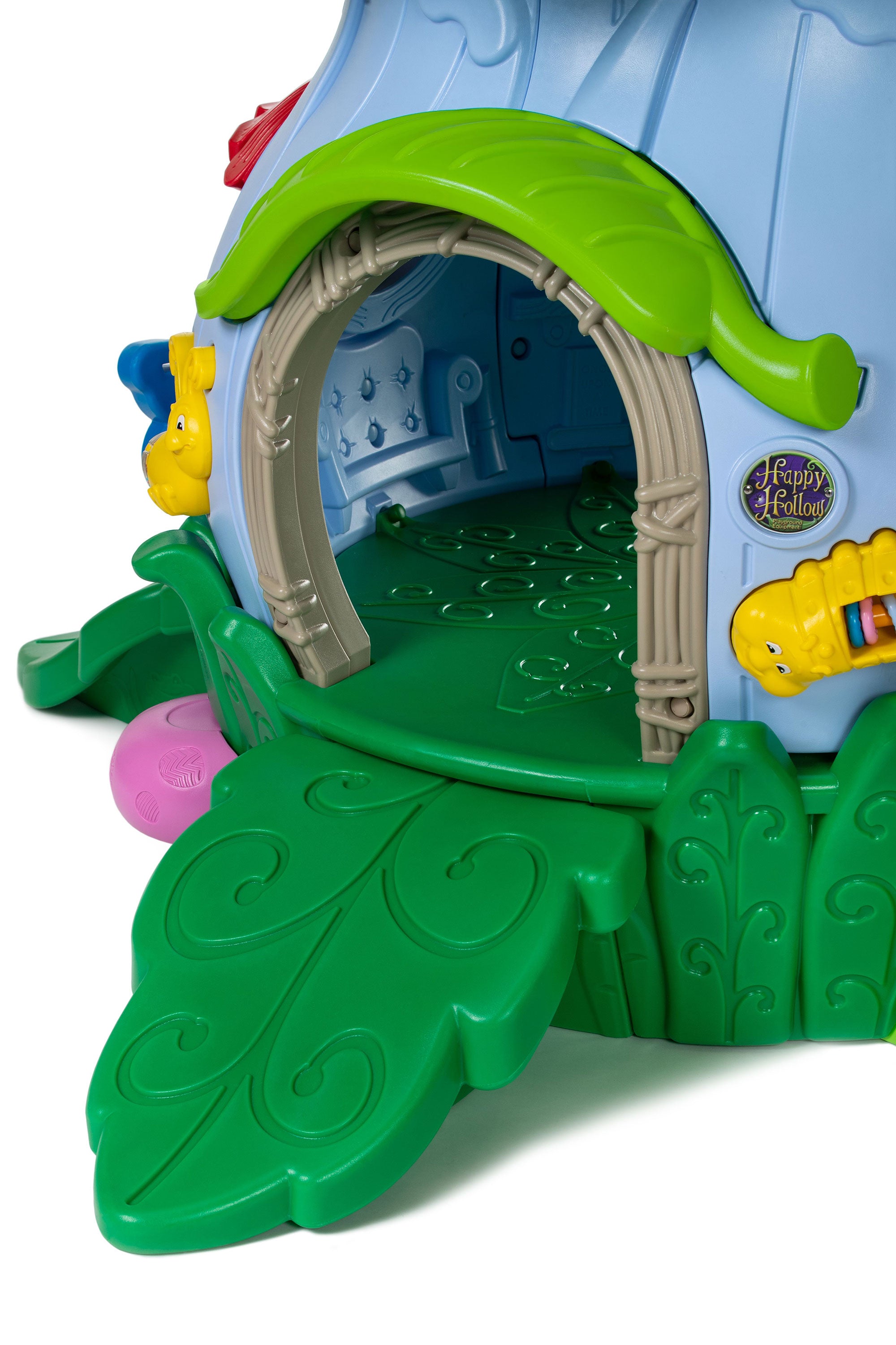Outdoor toddler playground playhouse with green leaf platform, arched vine-trim doorway, and yellow caterpillar bead panel.
