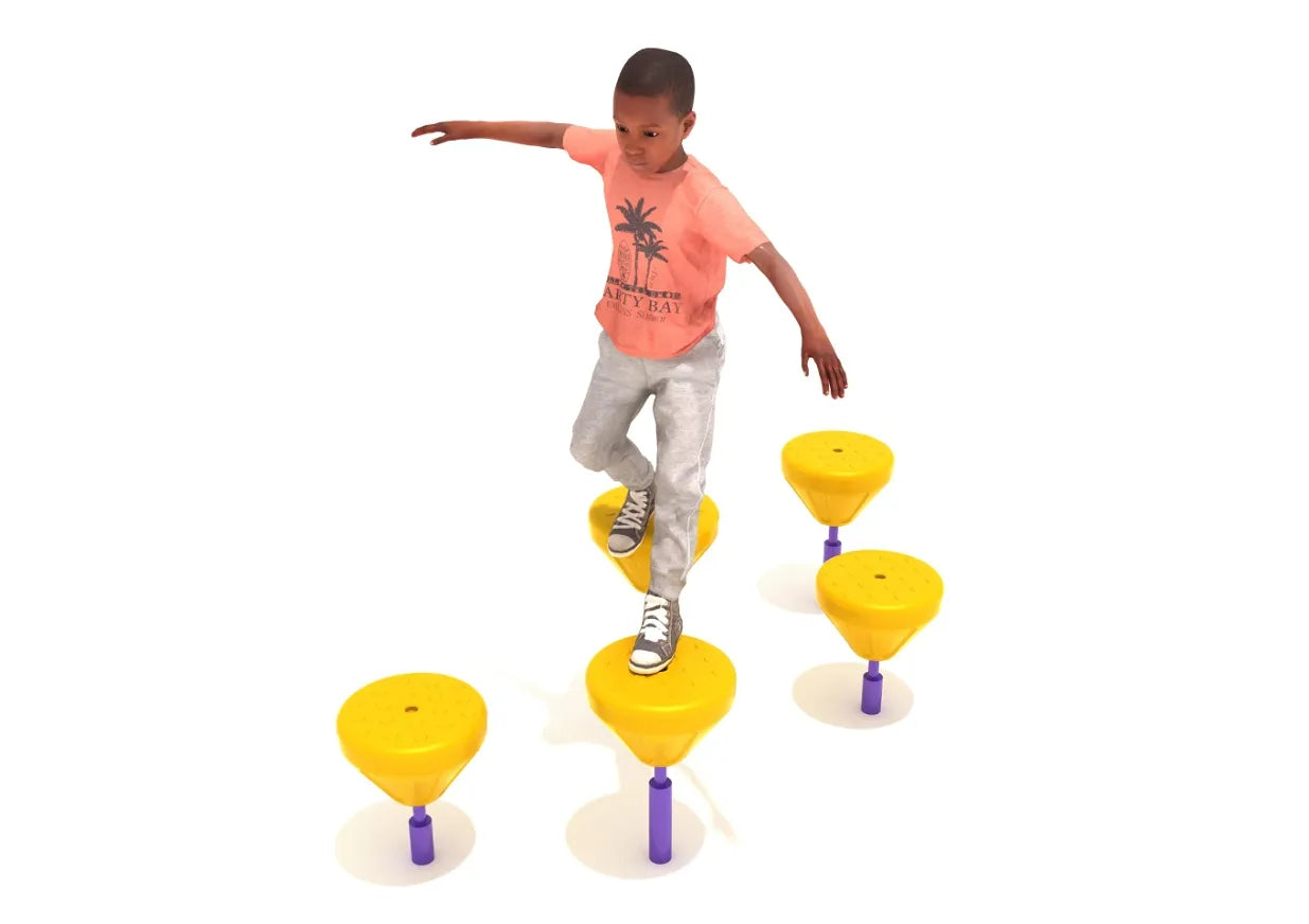 Child balancing on bright yellow tactile pebbles arranged in a staggered pattern for playground fitness and coordination