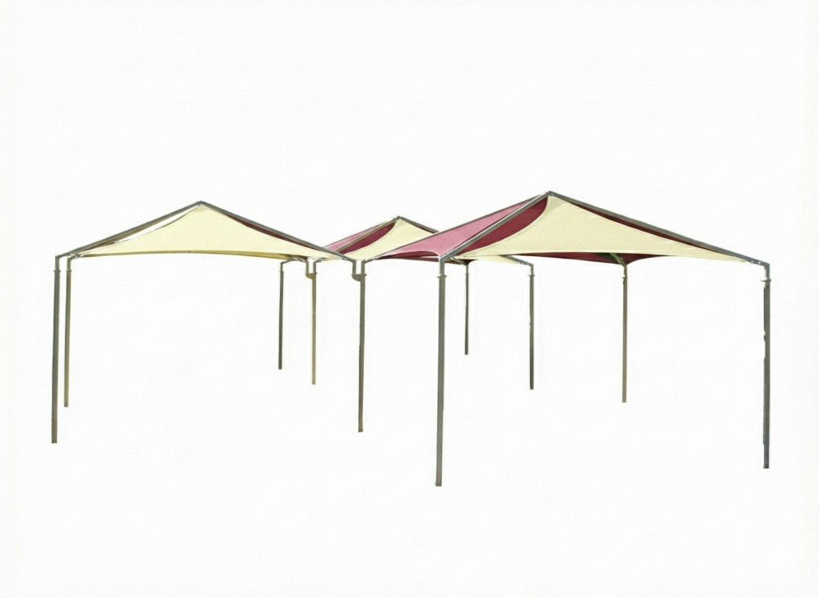 Pyramid Multi-Panel Shade Structure with four green and pink fabric panels and beige metal frame over picnic tables in park setting