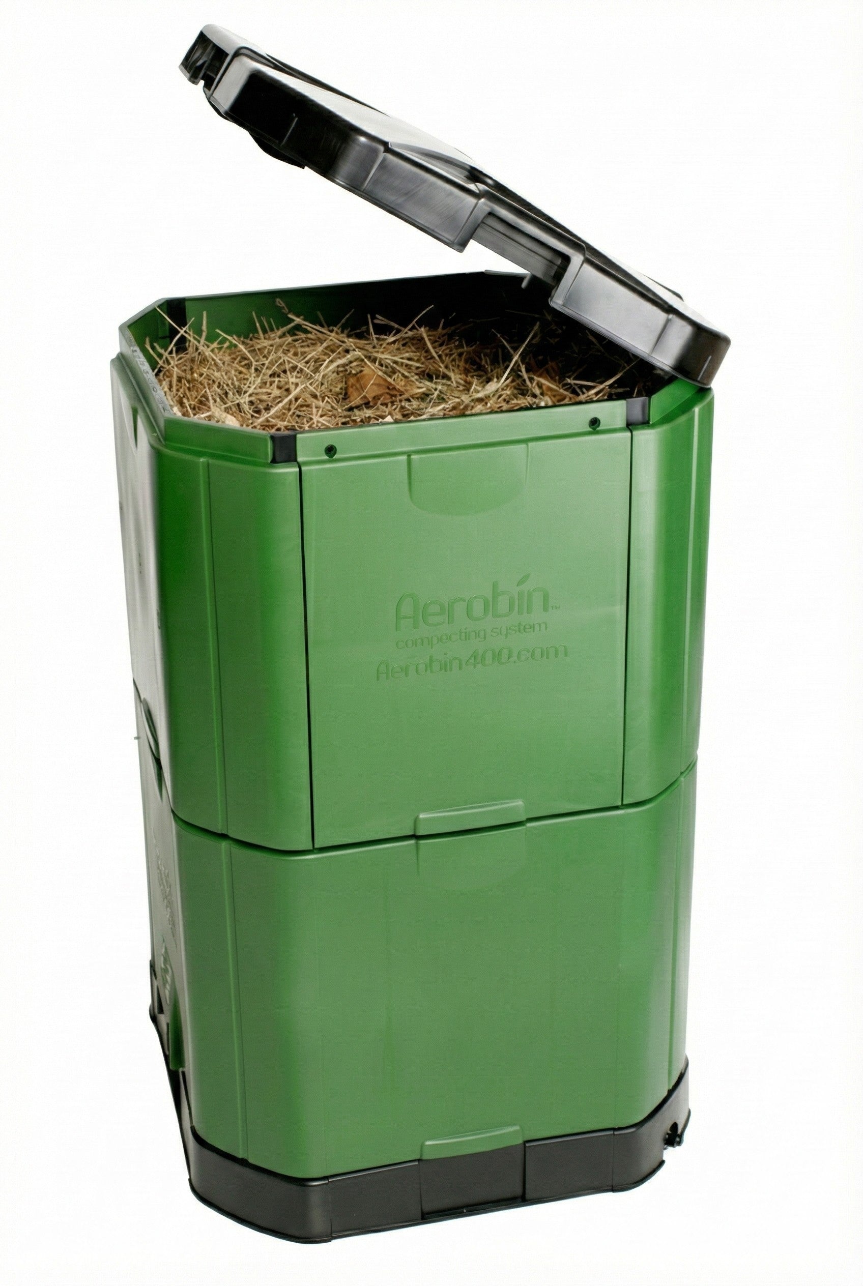 Aerobin 400 insulated compost bin with green garden waste, black lid open, woman adding kitchen scraps, aerobic composting design