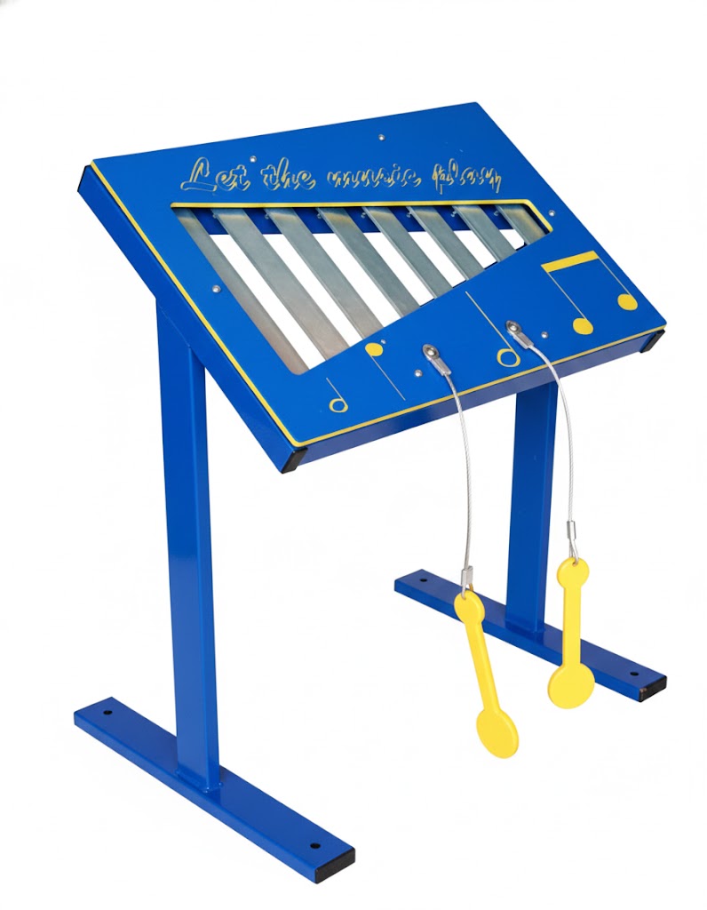 Xylophone Musical Freestanding Play Event with blue frame, metal bars, yellow musical note decorations, and attached yellow paddles on grass
