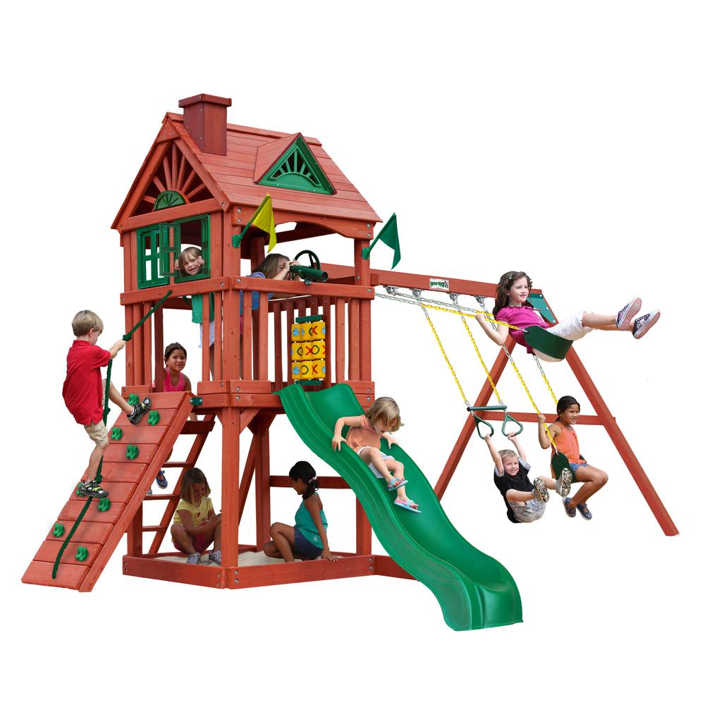 Nantucket Wooden Swing Set with redwood finish, clubhouse with working shutters, green wave slide, climbing wall, swings, and sandbox