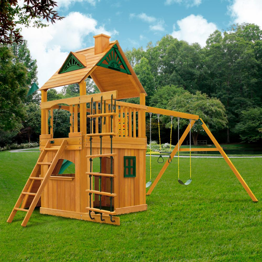Wooden outdoor playset with amber finish, green-trimmed roof, climbing ladder, two belt swings, and trapeze bar on grassy lawn