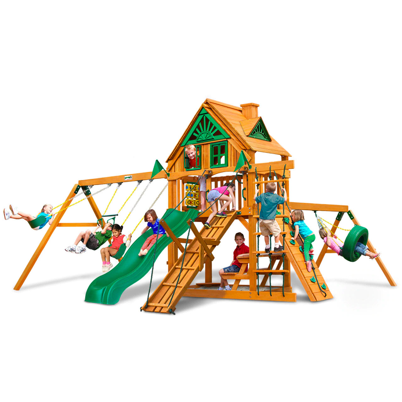 Cedar wooden playset with green slide, swings, climbing ramps, tire swing, and playhouse with windows and roof