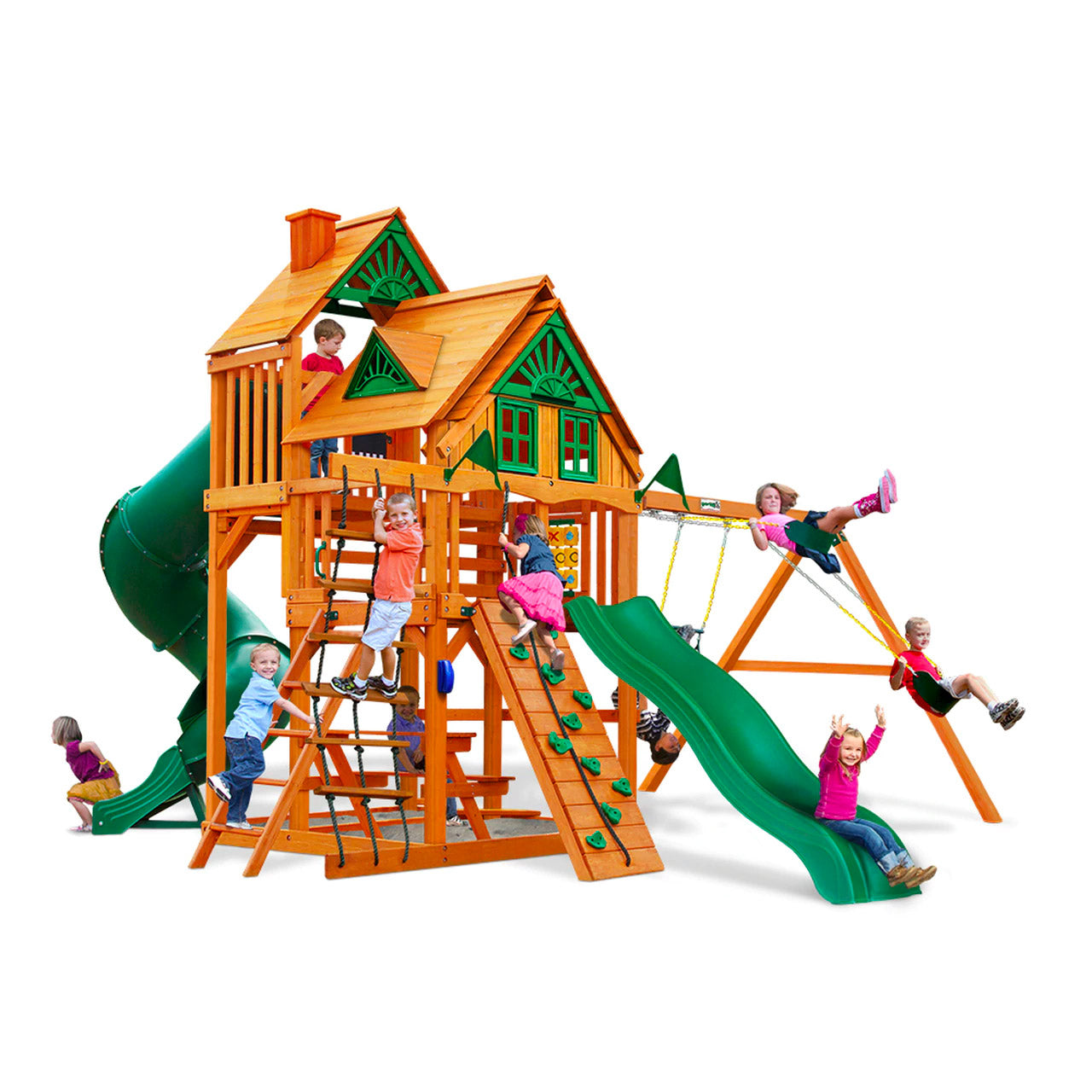 Cedar wooden playset with green slides, climbing wall, rope ladder, dual swings, trapeze swing, and children playing outdoors