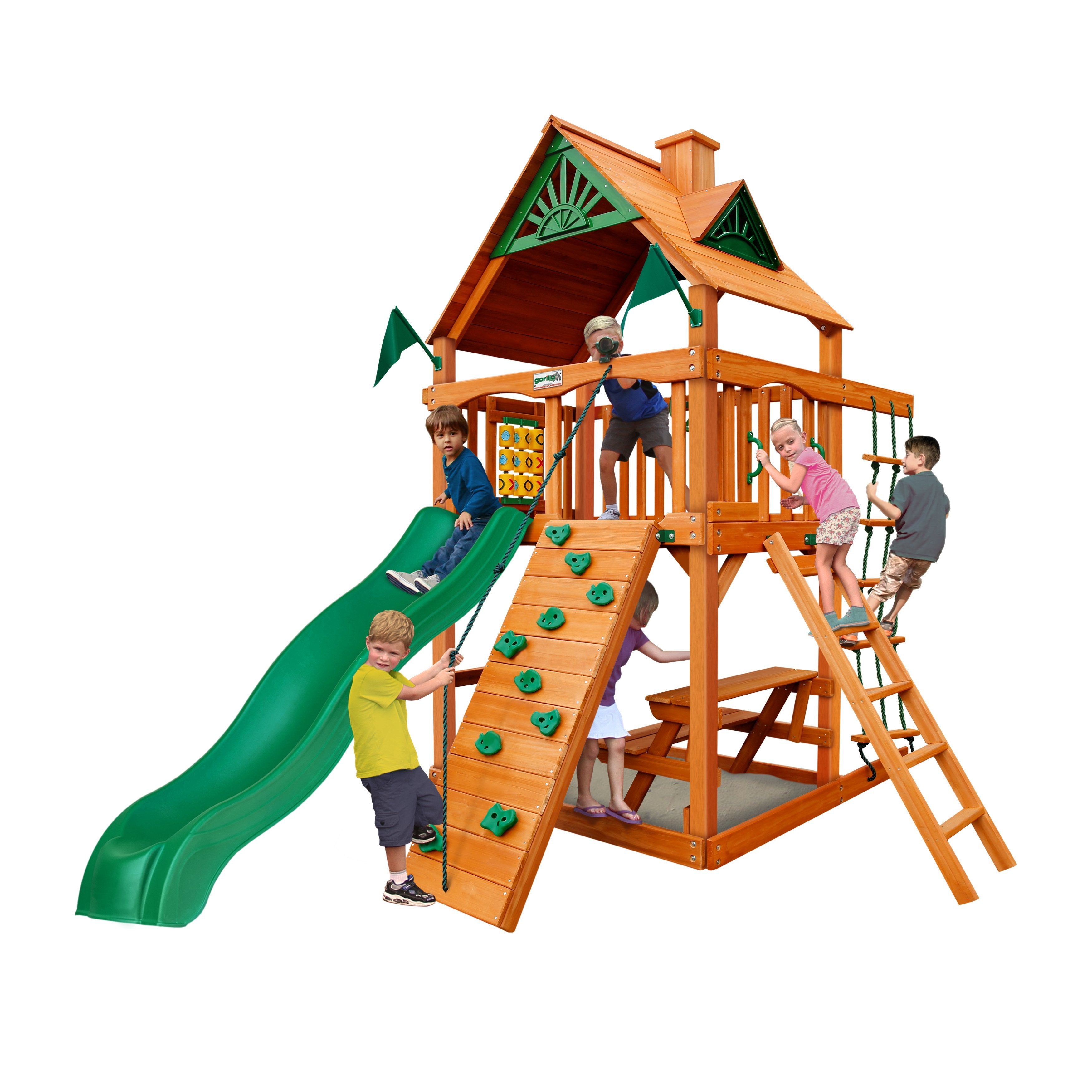 Chateau Tower AP Wooden Swing Set with cedar tower, green slide, rock climbing wall, rope ladder, picnic table, and children playing outdoors