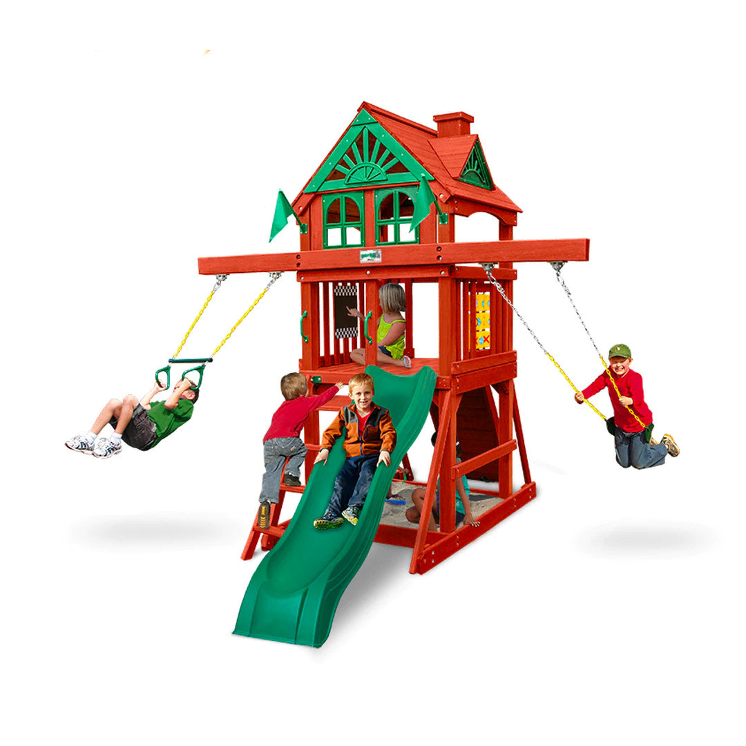 Wooden playset with green slide, two yellow belt swings, rock climbing wall, sandbox, and tic-tac-toe panel with children playing