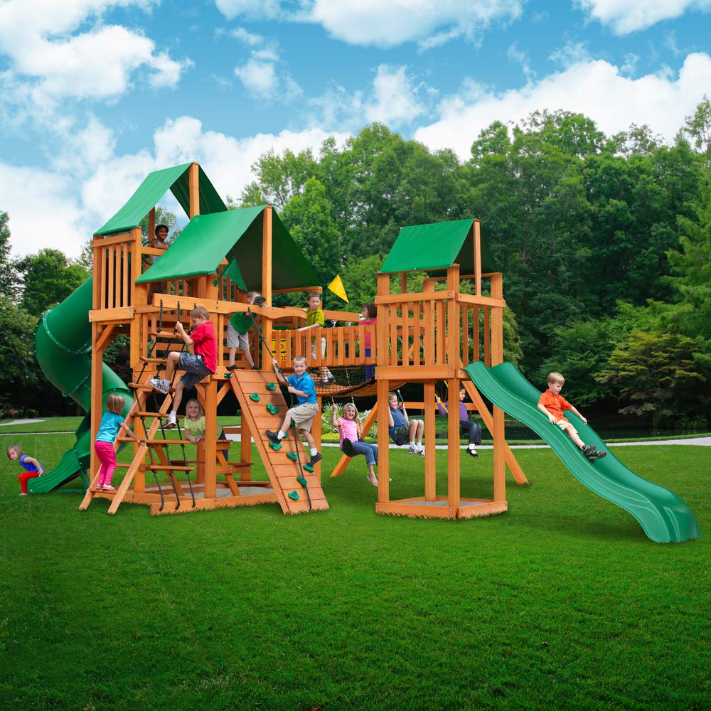 Wooden playset with green vinyl canopies, slides, climbing walls, swings, and children playing outdoors