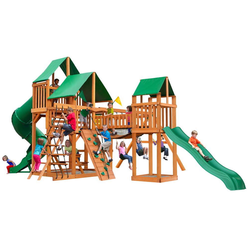 Wooden playset with green vinyl canopies, tube slide, rock climbing wall, swings, and children playing outdoors