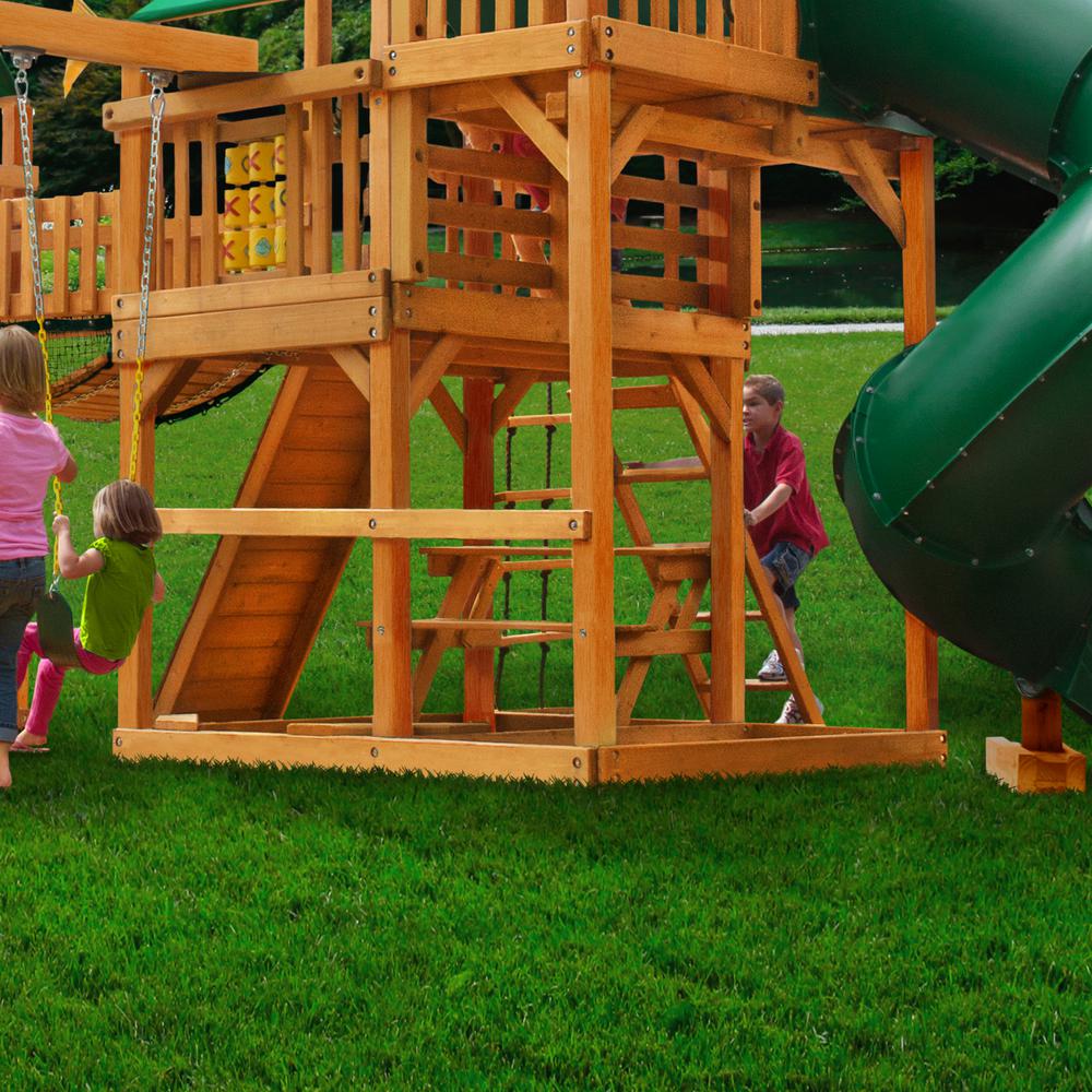 Cedar wooden playset with green tube slide, climbing ladder, tic-tac-toe panel, swings, and children playing