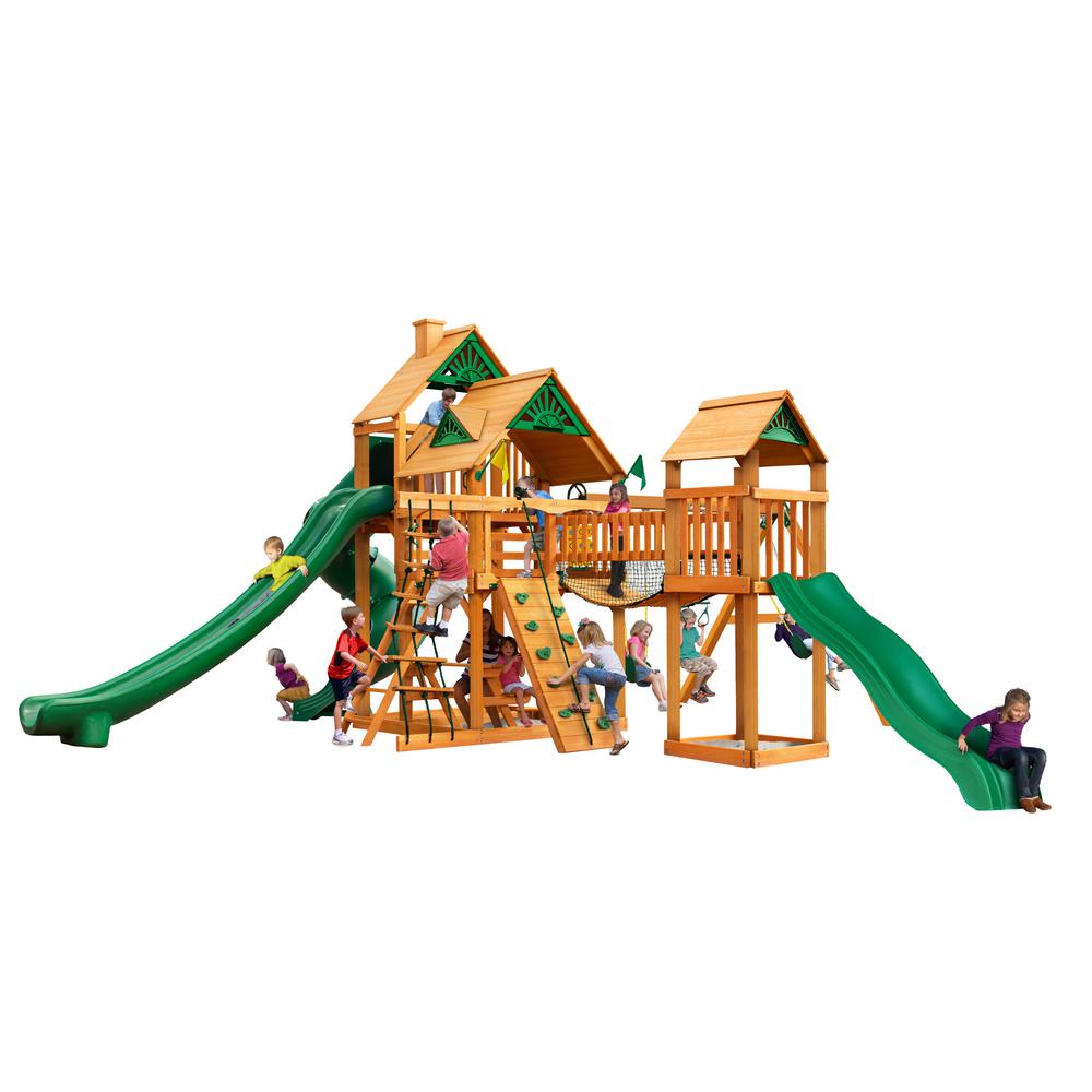 Treasure Trove II AP Wooden Swing Set with natural cedar finish, green slides, climbing walls, rope ladder, play towers, and children playing