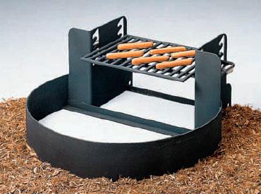 Fire Ring with Adjustable Grate 9" High black metal fire ring with elevated adjustable cooking grate holding hot dogs outdoors on ground