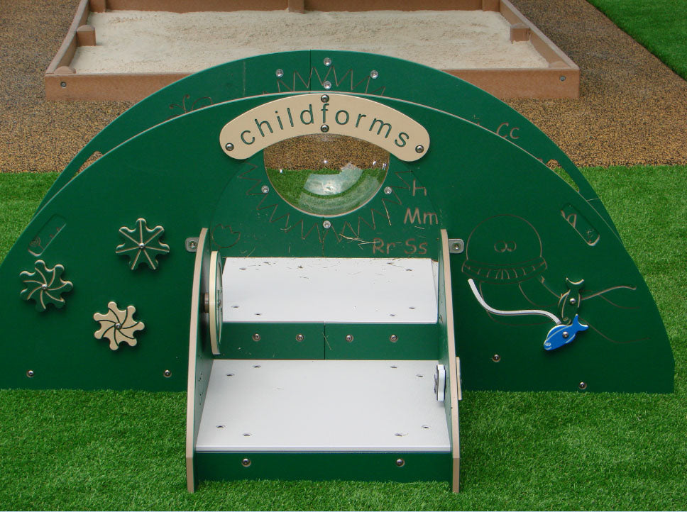 Indoor Tot Climber with green arch, white steps, interactive gears, and playful sea creature designs on artificial grass