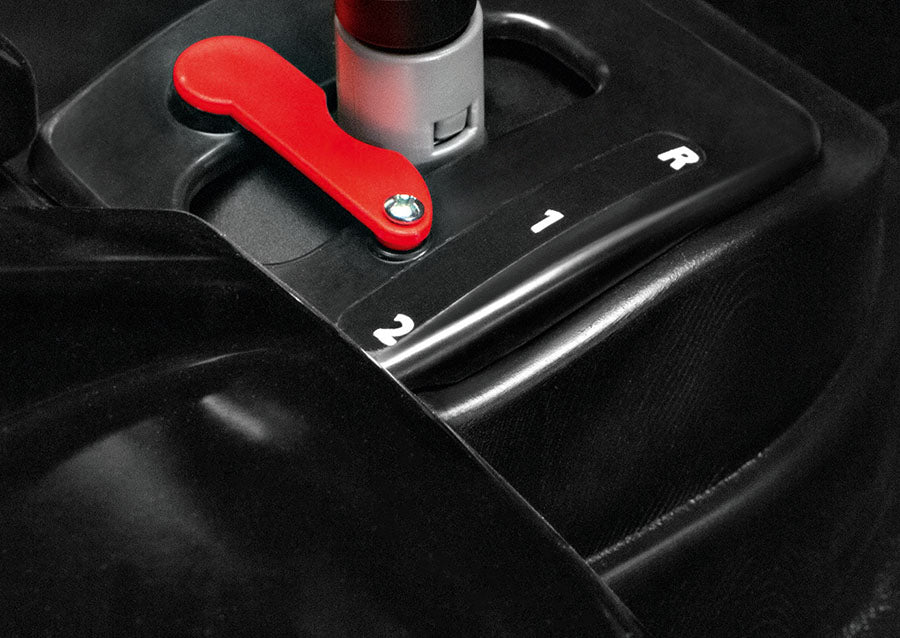 Red lever and black 2-speed shifter with reverse on a kids' camo electric ride-on vehicle control panel