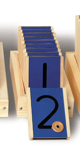 Motor Numbers Learning Tool with wooden tiles featuring cut-out numbers and a movable button for tactile tracing in a wooden holder