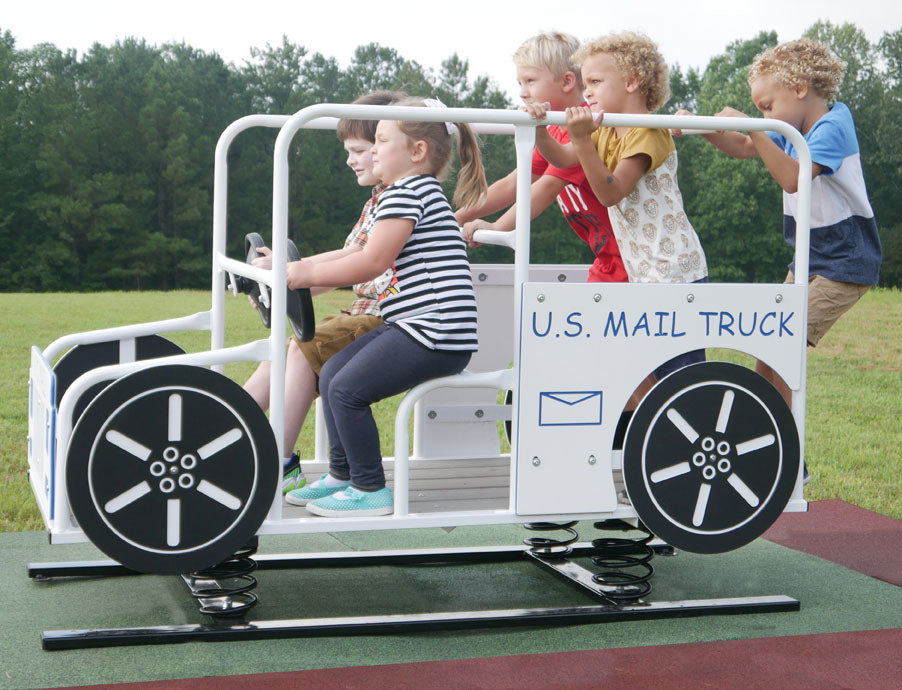 US Mail Multi Passenger Spring Rider with children playing, white and black mail truck design, outdoor playground setting