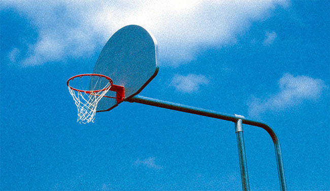 Outdoor basketball hoop with aluminum backboard, galvanized steel tandem post, and steel chain net against blue sky