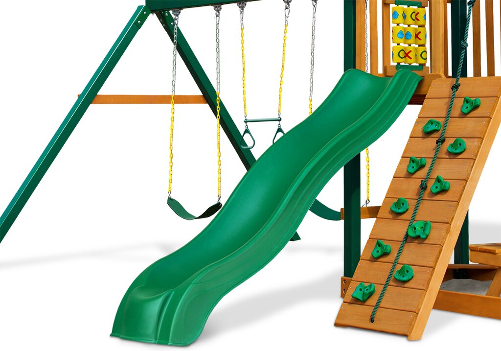 Green wave slide attached to wooden playset deck with climbing wall, swings, and tic-tac-toe panel, swing set accessory