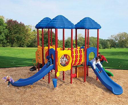 Colorful playground with three blue roofs, slides, climbing features, and children playing outdoors on a multi-level play system